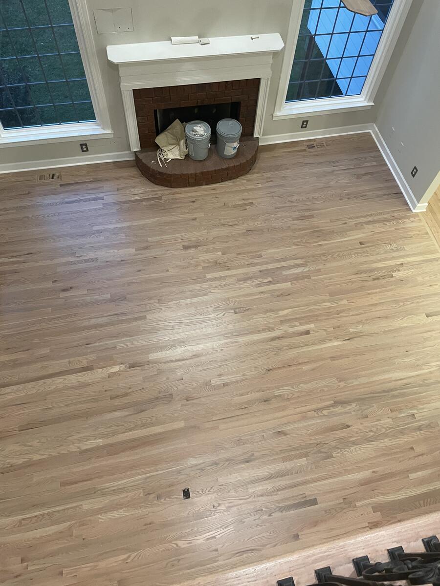 Natural sanded hardwood floor with fireplace
